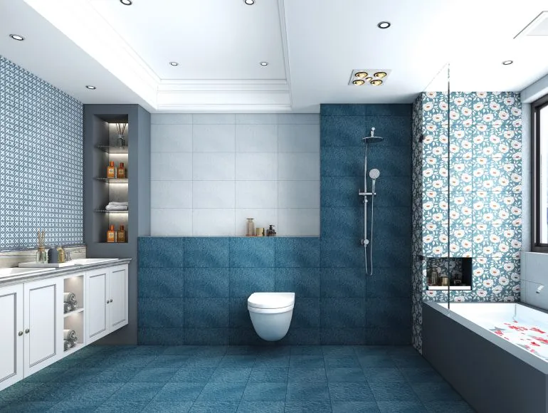 Elegant blue bathroom design with bathtub, sink and western toilet for a sleek look